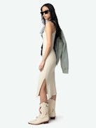 Astra Dress - A sleek tank dress that embodies the brand's signature edgy elegance. This white dress features distinctive wing-shaped embellishments on the front, adding a unique flair to its minimalist design. The Astra Dress is a versatile addition to any wardrobe, seamlessly transitioning from day to night with effortless style.