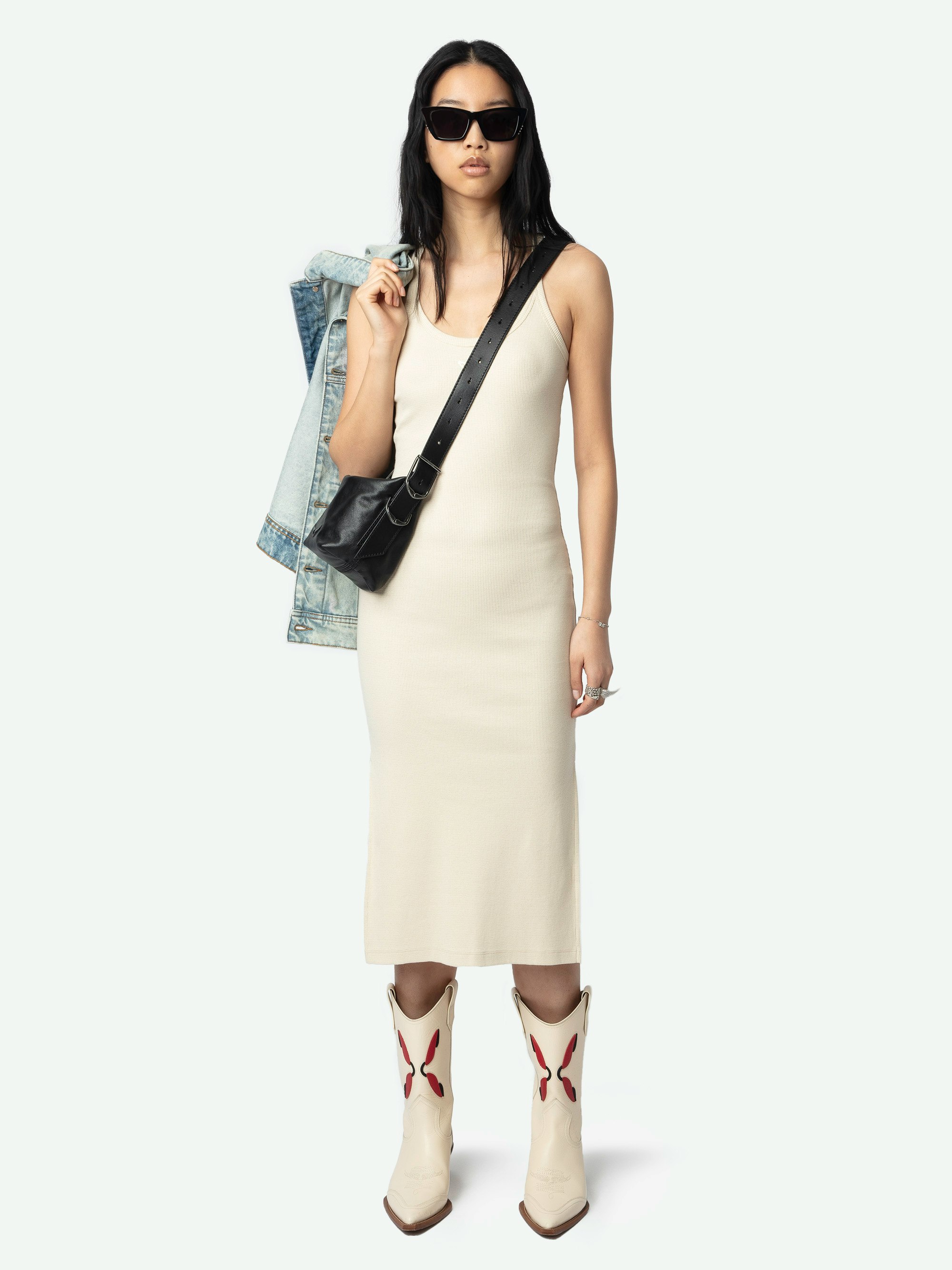 Astra Dress - A sleek tank dress that embodies the brand's signature edgy elegance. This white dress features distinctive wing-shaped embellishments on the front, adding a unique flair to its minimalist design. The Astra Dress is a versatile addition to any wardrobe, seamlessly transitioning from day to night with effortless style.