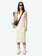 Astra Dress - A sleek tank dress that embodies the brand's signature edgy elegance. This white dress features distinctive wing-shaped embellishments on the front, adding a unique flair to its minimalist design. The Astra Dress is a versatile addition to any wardrobe, seamlessly transitioning from day to night with effortless style.