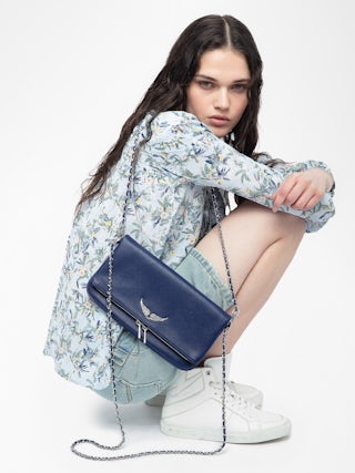 Rock Clutch - Grained leather pochette with double leather and metal chains and rhinestone-embellished wings.