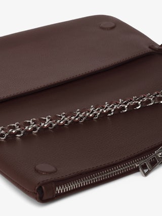 Rock Clutch - Grained leather clutch with double leather and metal chains and rhinestone-embellished wings.
