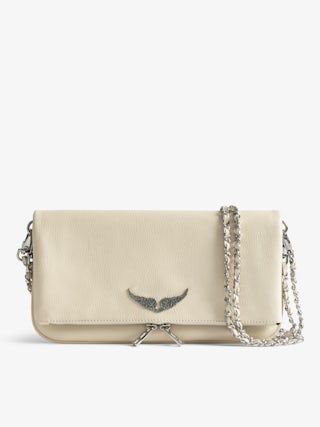 Rock Clutch - Clutch in grained leather with double leather and metal chains and wings adorned with rhinestones.