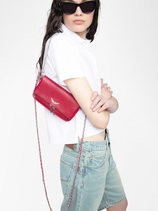 Rock Clutch - clutch in grained leather with double leather and metal chains and rhinestone-adorned wings.