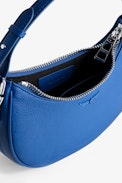 Moonrock Bag - Women’s half-moon bag in blue grained leather with a short handle, shoulder strap, chain and signature wings.