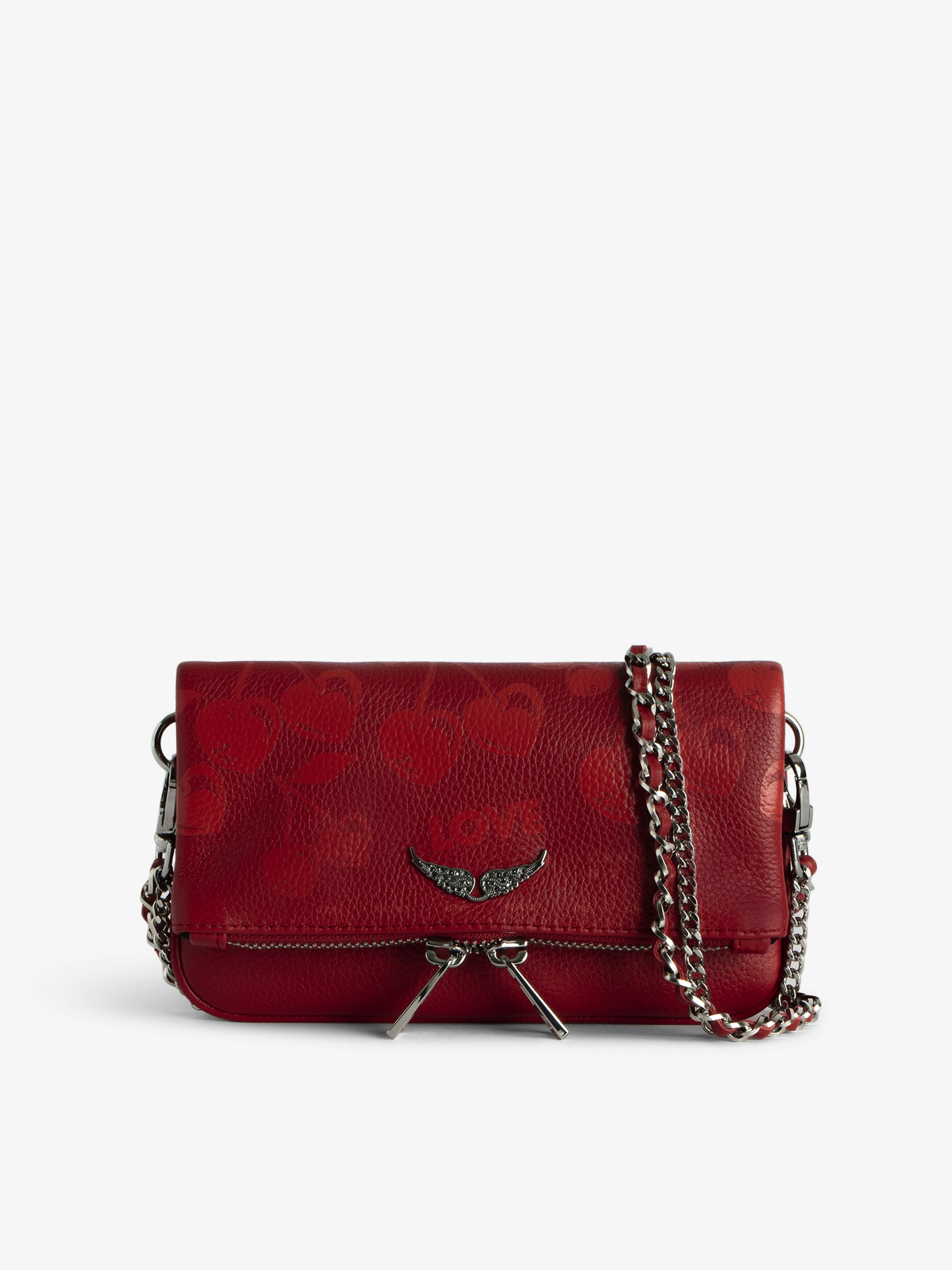 Rock Nano Tasche - Cherry Clutch aus genarbtem Leder mit Signature-Metallflügeln und Strassbesatz.