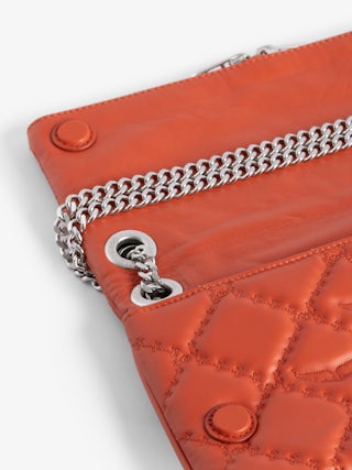 Rock II Quilted Monogram Clutch - Clutch in smooth quilted leather with sliding metal chain and signature wings.