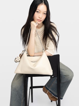 Tasche Jim - Weiche Tasche aus genarbtem Leder mit Kette und Flügel mit Strasssteinen verziert.