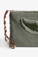 Uma Clutch - Women's khaki cotton clutch bag with fringing, wing patch and a beaded strap