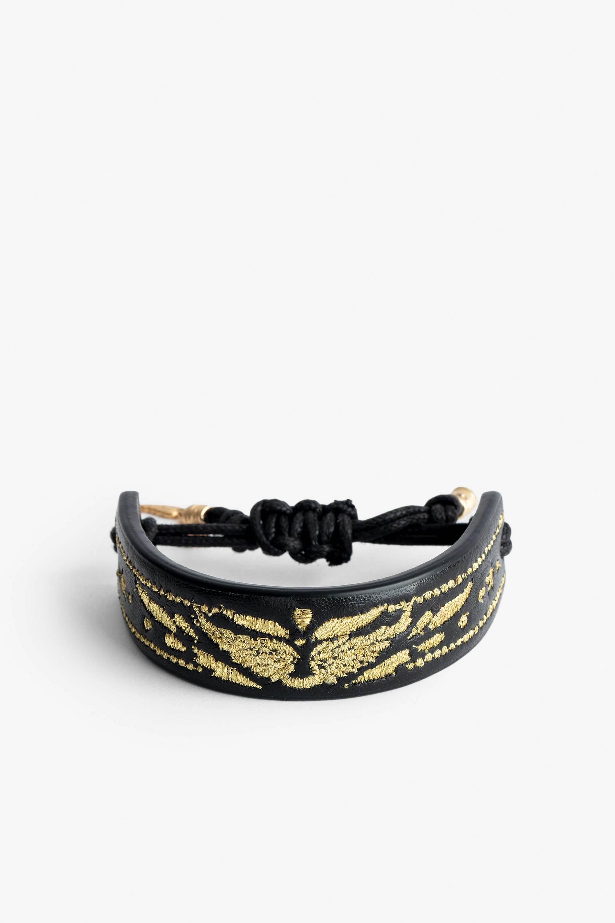 Armband Lenny  - Voltaire Vice Manschettenarmband aus schwarzem Leder zum Knüpfen mit goldenen Flügeln.