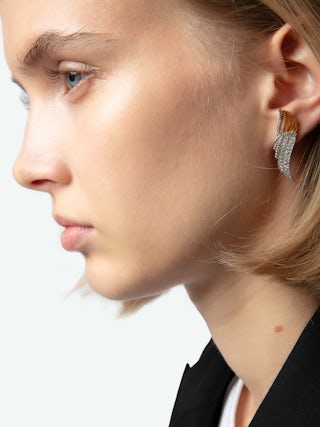 Rock Over Earrings - Gold-tone brass earrings with wings embellished with silver crystals.