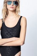 Jeri Swimsuit - Zadig&Voltaire women's black one-piece swimsuit, grey "wings" cross pattern.
Model made in Italy. 
Wash swimsuits by hand and dry them in the open air to maintain the quality of colors and fibres.