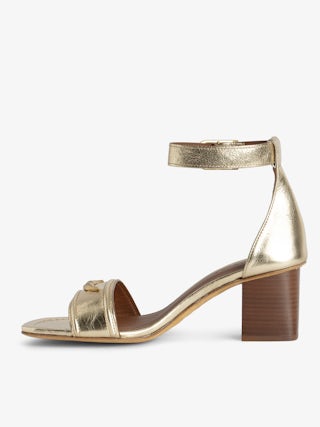 Caprese Sandals - Heeled sandals with leather strap adorned with a wing charm and a signature buckle.