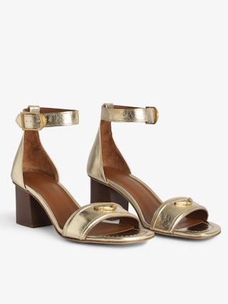 Caprese Sandals - Heeled sandals with leather strap adorned with a wing charm and a signature buckle.
