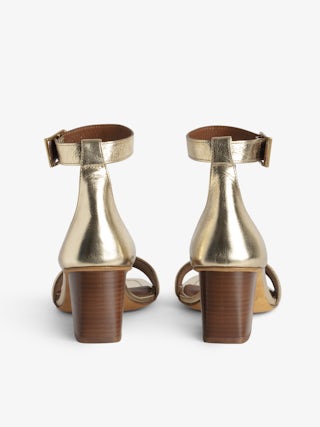 Caprese Sandals - Heeled sandals with leather strap adorned with a wing charm and a signature buckle.