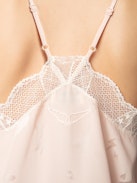 Christy Heart Camisole - A delicate blend of romance and modern style. This lingerie-inspired pink silk camisole features the exclusive Flash Hearts print, adding a playful touch to its elegant design. Crafted from luxurious silk, it offers a soft and comfortable feel against the skin. The V-neckline is adorned with contrasting lace trim, enhancing its feminine appeal, while the thin, adjustable spaghetti straps ensure a personalized fit. Its versatile style makes it a perfect addition to any wardrobe, suitable for both casual layering and sophisticated ensembles.