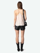 Christy Heart Camisole - A delicate blend of romance and modern style. This lingerie-inspired pink silk camisole features the exclusive Flash Hearts print, adding a playful touch to its elegant design. Crafted from luxurious silk, it offers a soft and comfortable feel against the skin. The V-neckline is adorned with contrasting lace trim, enhancing its feminine appeal, while the thin, adjustable spaghetti straps ensure a personalized fit. Its versatile style makes it a perfect addition to any wardrobe, suitable for both casual layering and sophisticated ensembles.