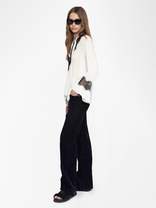 Tuan Lace Shirt - The Tuan shirt plays contrast with a soft ivory silk and bold black lace trim. Effortlessly sensual, it drapes with attitude—open neckline, flared cuffs, and just the right amount of rebellion.