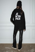 Salma Cardigan - Women’s black knit cardigan with zip fastening and hood with the slogan “Je m’en fous” on the back